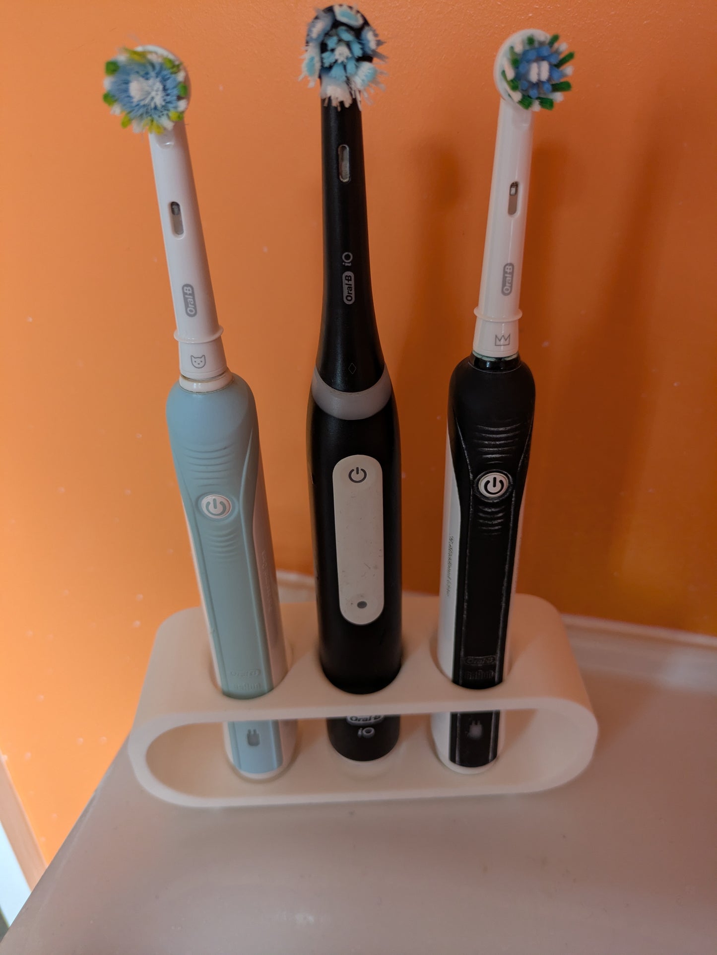 Toothbrush holder for 3 Oral B electric toothbrushes