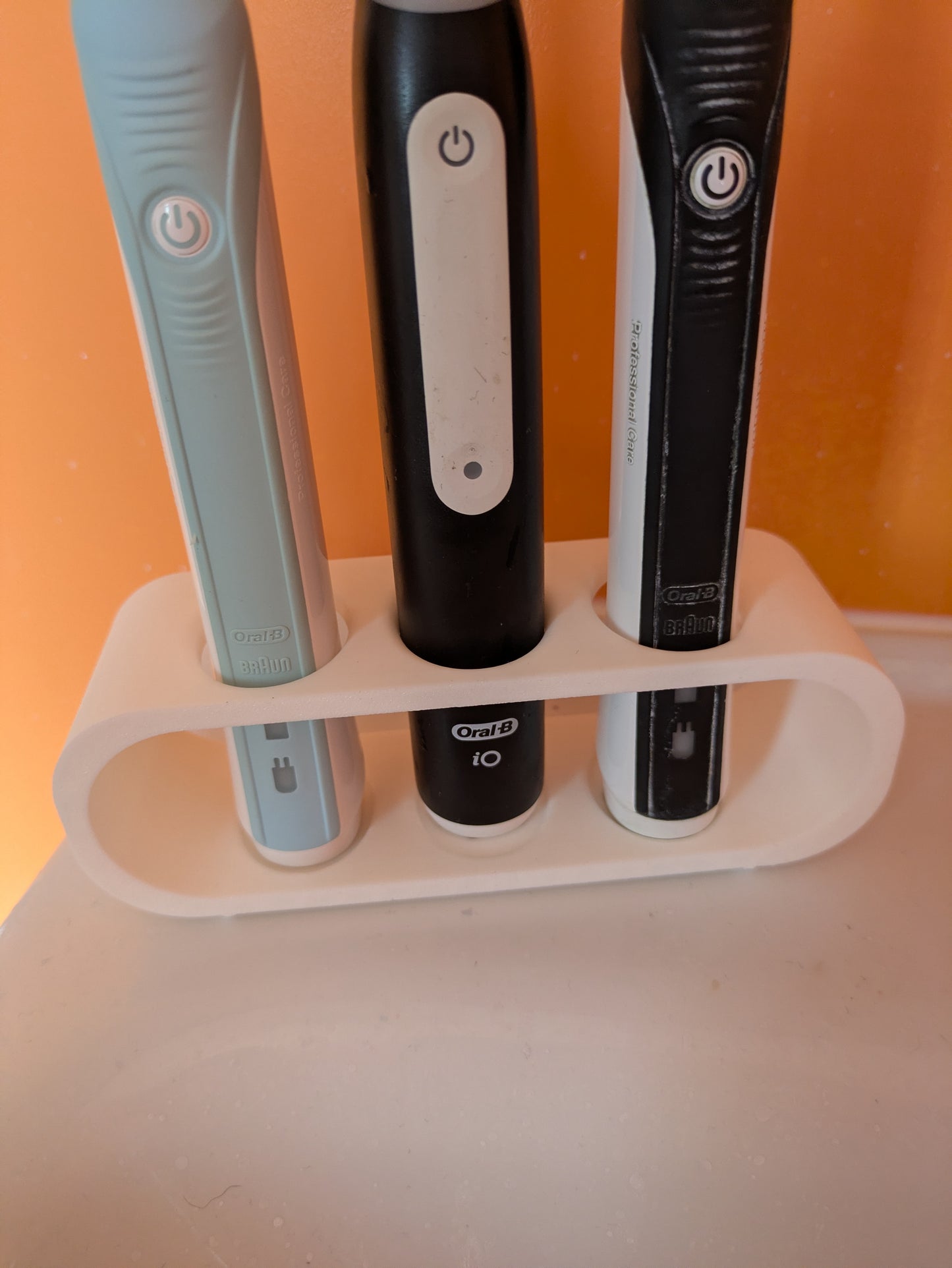 Toothbrush holder for 3 Oral B electric toothbrushes