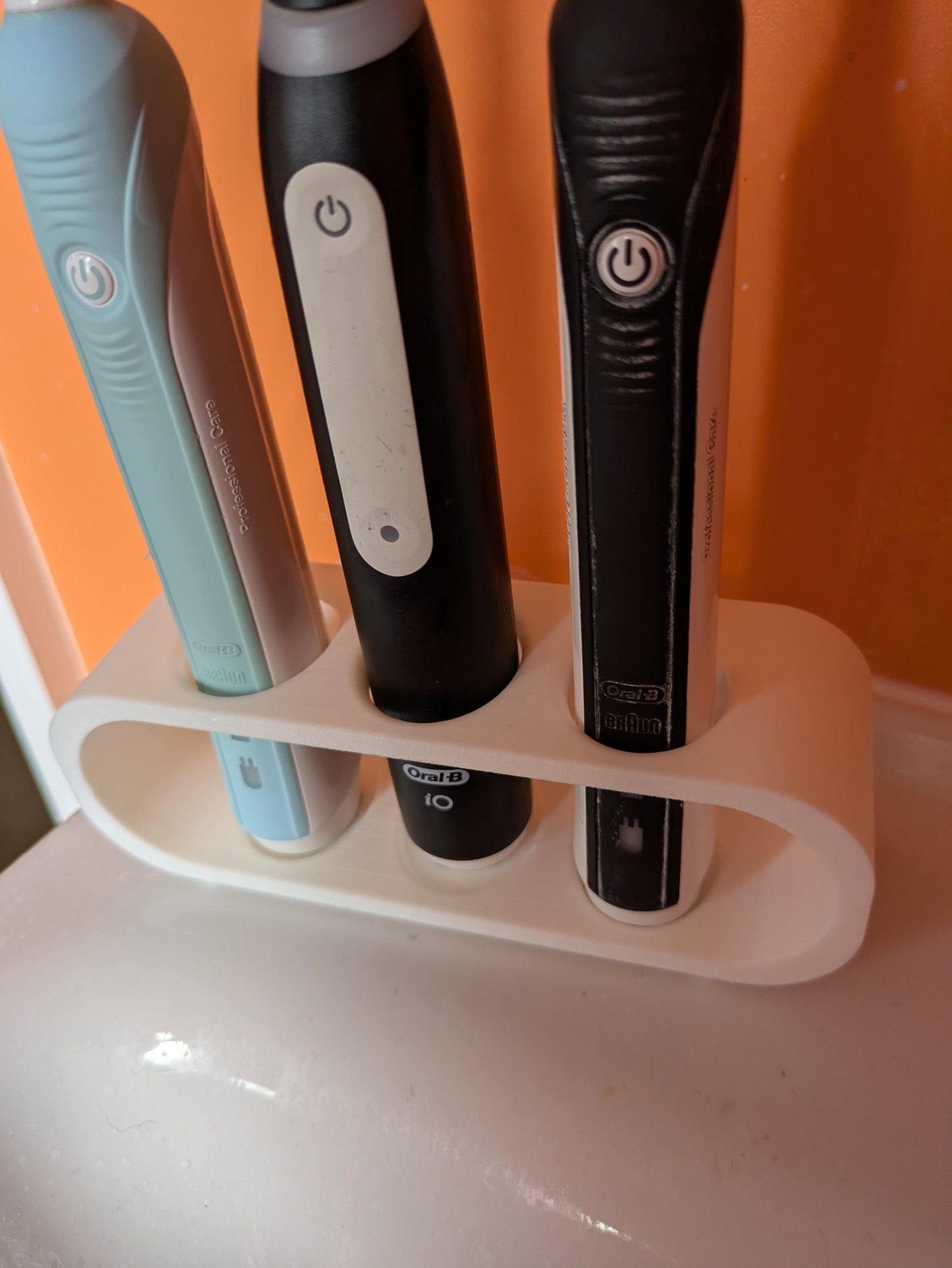 Toothbrush holder for 3 Oral B electric toothbrushes